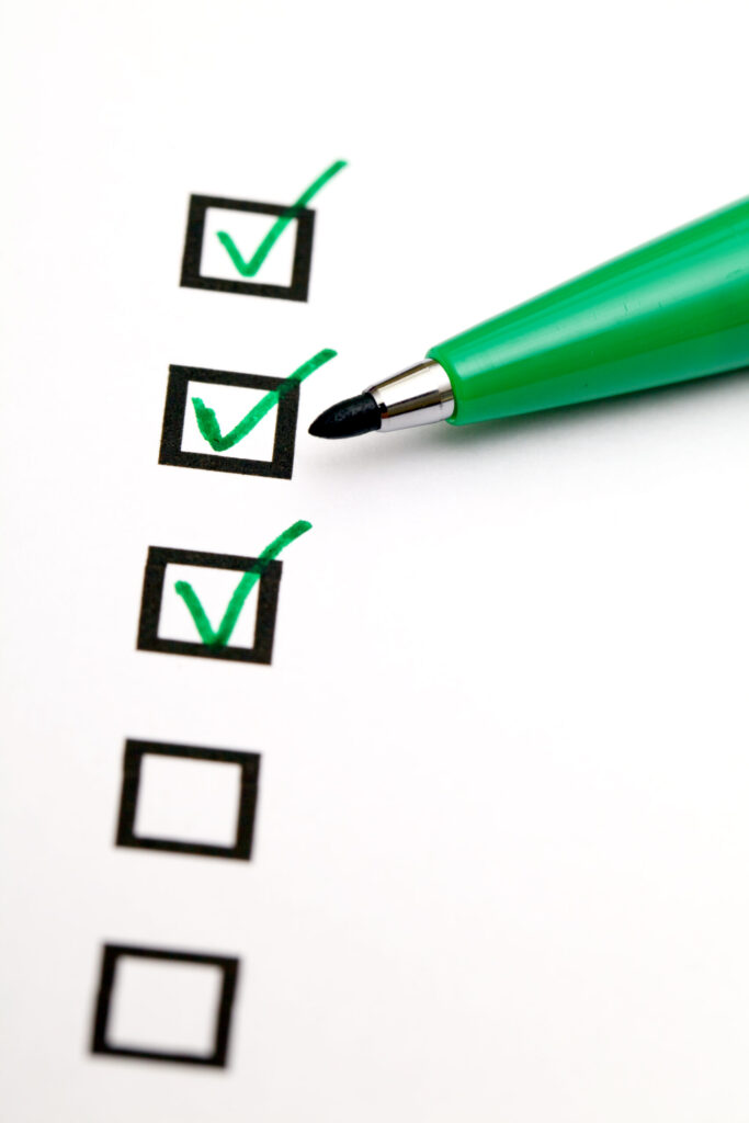 Checklist with green checkmarks and a green pen, emphasizing gas line inspection requirements for safety compliance.