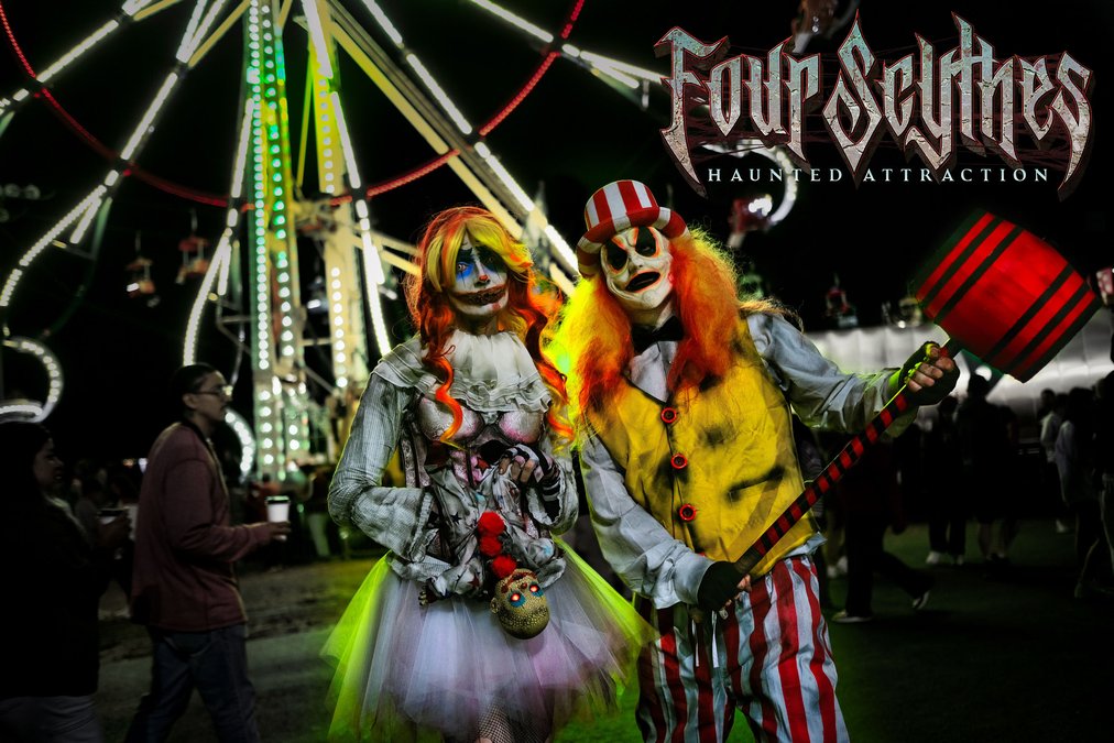 Clown and creepy character posing at night with Ferris wheel in background, promoting Four Scythes Haunted Attraction in Cumming, Georgia.