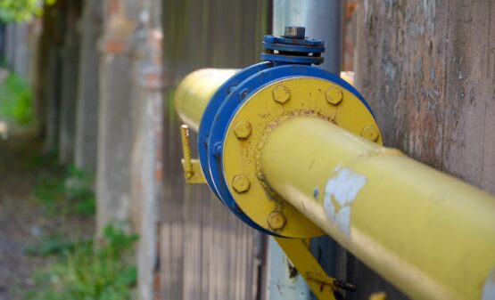 Yellow gas pipeline with blue fittings, illustrating gas line infrastructure relevant to maintenance and repair discussions for homeowners in Cumming, GA.