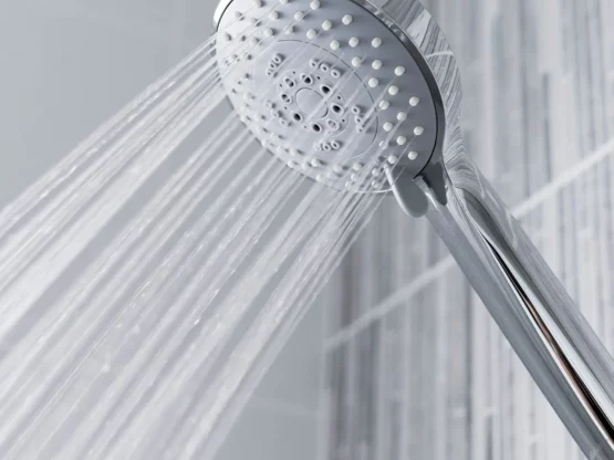 Replacement shower head with multiple spray settings and water flowing, enhancing daily shower experience.