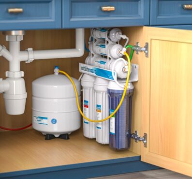 Reverse osmosis water purification system installed under kitchen sink, featuring multiple filters and a storage tank, promoting clean drinking water and reducing contaminants.